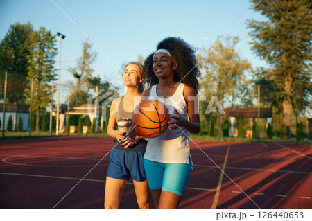 Happy joyful woman sharing impression after basketball game session Happy joyful woman sharing impression after basketball game session 126440653