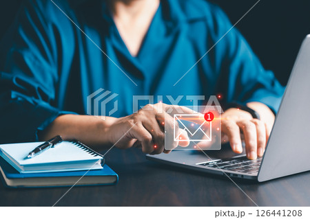 Company uses email marketing to send out engaging newsletters and promotional content through electronic mail in cyberspace, reaching customers online. email, mail, content, marketing, newsletter. 126441208