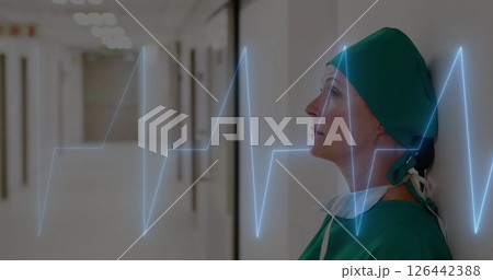 Image of cardiograph over caucasian female doctor sitting 126442388