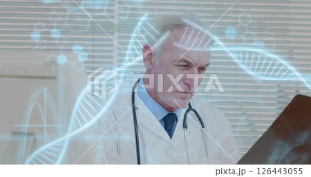 Image of dna strands with data processing over caucasian male doctor reading x-ray scan Image of dna strands with data processing over caucasian male doctor reading x-ray scan 126443055