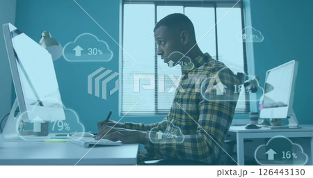 Image of clouds with percent growing over african american businessman in office Image of clouds with percent growing over african american businessman in office 126443130