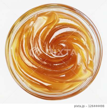 Swirl of golden apple jam in glass bowl isolated on white background, top view, copy space 126444498