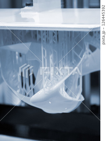 Printed models on 3D printer close-up. Objects printed on photopolymer sla 3D printer from liquid photopolymer resins on printing platform. Modern additive technology. 3D printer printing. Blue color Printed models on 3D printer close-up. Objects printed on photopolymer sla 3D printer from liquid photopolymer resins on printing platform. Modern additive technology. 3D printer printing. Blue color 126445392