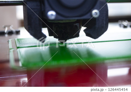 The process of printing on 3D printer. 3D printer creating model from molten plastic close-up. Molten plastic flowing of extruder and forming three-dimensional volumetric object. Additive technologies 126445454