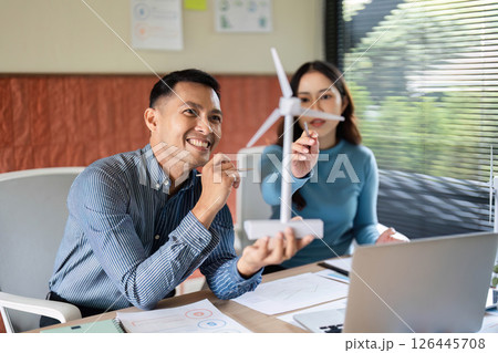 ESG Collaboration. Professionals discussing renewable energy solutions in a modern workspace. 126445708