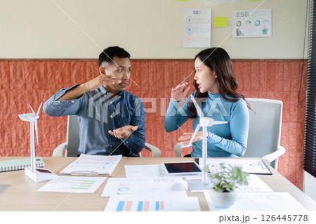 ESG Collaboration. Professionals brainstorming on renewable energy solutions in a modern office. ESG Collaboration. Professionals brainstorming on renewable energy solutions in a modern office. 126445778