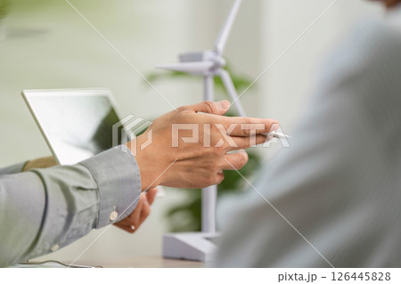 ESG Consultation. Professional discussing sustainable business practices with client. 126445828