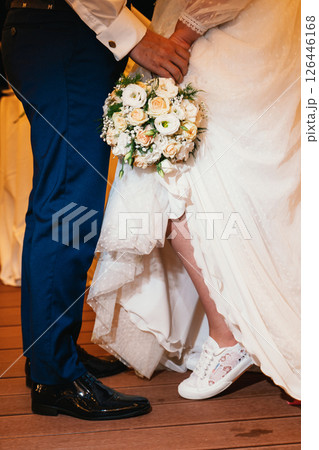 Bride and Groom with Bouquet and Sneakers at Wedding 126446168