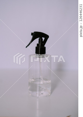 Clear Spray Bottle with Black Nozzle, Minimalist Composition 126446231