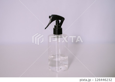 Clear Spray Bottle with Black Nozzle, Minimalist Composition 126446232