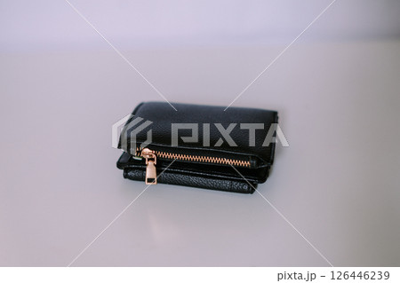 Close-up view of a sophisticated black leather wallet on neutral backdrop 126446239