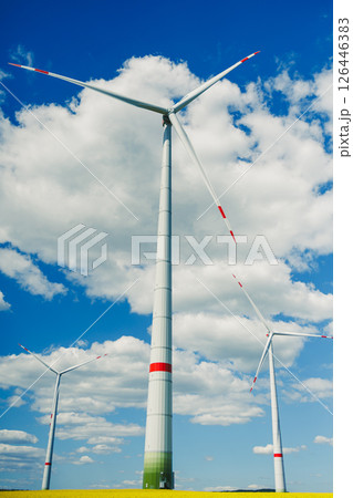 Windmill for generating energy against a blue sky. Windmill in a rural area in Europe. Windmill for generating energy against a blue sky. Windmill in a rural area in Europe. 126446383