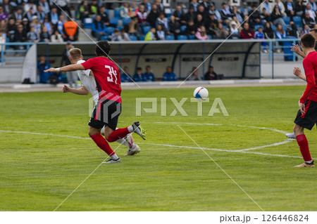 Football players at the stadium with the ball score a goal in the goal Football players at the stadium with the ball score a goal in the goal 126446824