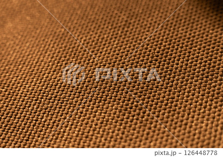 Close-up texture of textile surface. Extreme macro close-up of synthetic fabric surface. Gold background in shallow depth of field 126448778