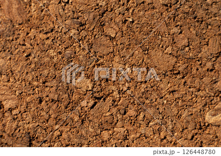 Close-up with shallow depth of field. Surface of pressed cork wood. Orange warm background 126448780