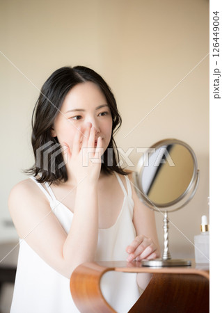 鏡をみる素肌感が美しい若い女性の美容やビューティーイメージクローズアップ 目元を気にする 鏡をみる素肌感が美しい若い女性の美容やビューティーイメージクローズアップ 目元を気にする 126449004