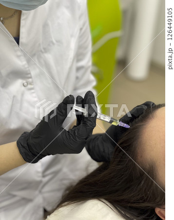 Trichologist giving injection to patient in clinic, closeup. Space for text. Medical aesthetic concept 126449105