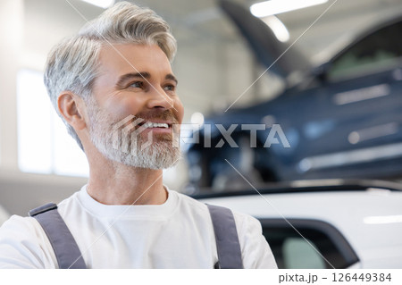 Mechanic with arms crossed near vehicle Mechanic with arms crossed near vehicle 126449384