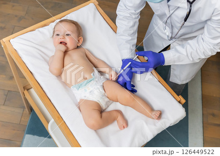 Doctor doing vaccination to a little cute baby boy Doctor doing vaccination to a little cute baby boy 126449522