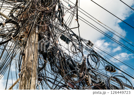 tangled wires on a pole close-up on a street in Thailand tangled wires on a pole close-up on a street in Thailand 126449723