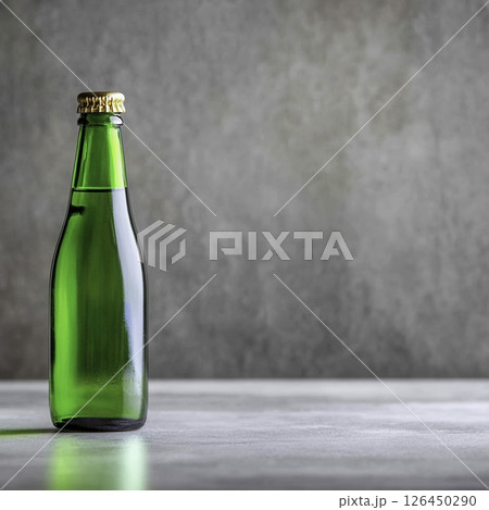 Green Glass Bottle with Cap on a Simple Gray Background Ready for Product Photography 126450290