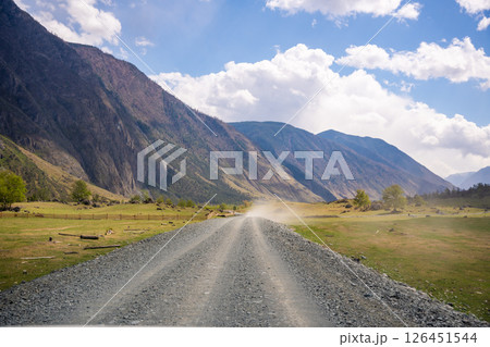 Dirt road running along Chulyshman river at entrance to Chulyshman valley in Altai Russia Scenic remote route through wild mountain landscape Dirt road running along Chulyshman river at entrance to Chulyshman valley in Altai Russia Scenic remote route through wild mountain landscape 126451544