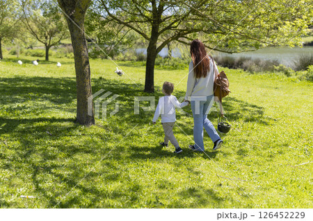 Mother and child walking in sunny park 126452229
