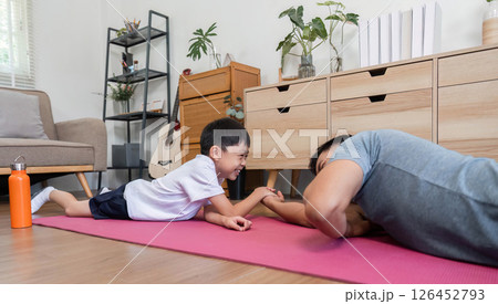 Family fitness fun father and son having fun arm wrestling at home 126452793