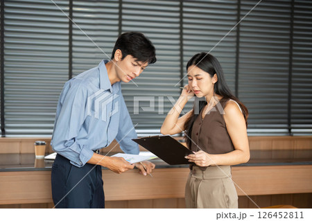 Business Interaction. Young professionals engaged in a project discussion at the office. 126452811