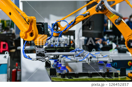 Robot arm control the Steel sheet cutting process in the industrial factory Robot arm control the Steel sheet cutting process in the industrial factory 126452857