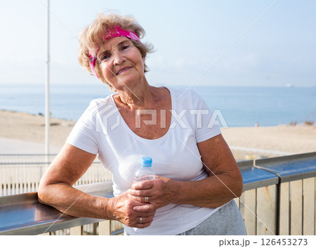 Portrait of an woman having rest after doing sports outdoors 126453273