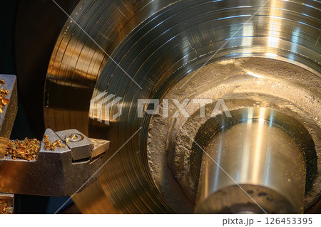 Close up scene the lathe machine finish cut the brass material parts by chip insert tool. Close up scene the lathe machine finish cut the brass material parts by chip insert tool. 126453395