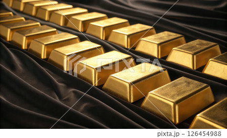 Close up of gold bars arranged black fabric, shiny and luxurious 126454988