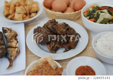 A Complete Indonesian Meal Rice, Fried Chicken, Vegetables and Eggs 126455141