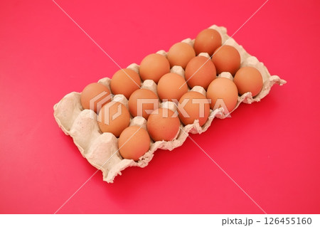 A basket filled with fresh brown eggs 126455160