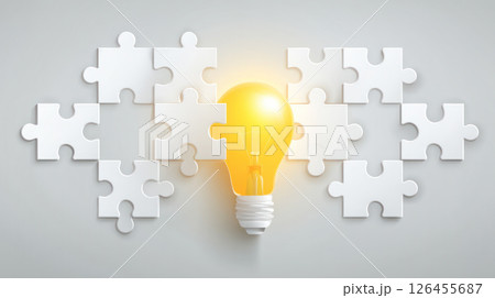 Light bulb glowing brightly surrounded by white puzzle pieces on a light gray background, symbolizing creativity, problem-solving, teamwork and brainstorming in idea generation and innovative thinking Light bulb glowing brightly surrounded by white puzzle pieces on a light gray background, symbolizing creativity, problem-solving, teamwork and brainstorming in idea generation and innovative thinking 126455687