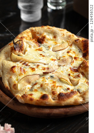 Portion of italian pizza with cheese and pears 126456522