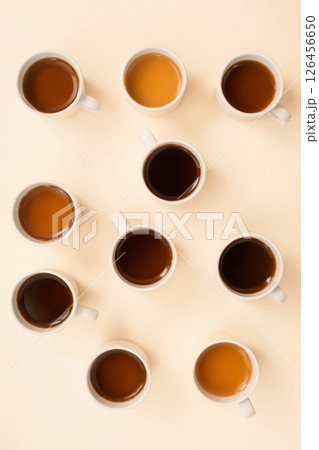 many mugs with different coffee on a pastel table top many mugs with different coffee on a pastel table top 126456650