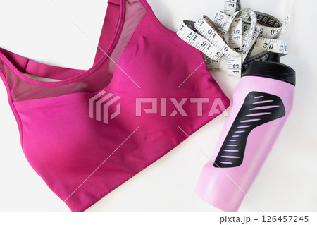 Concept of sports lifestyle and sports activities. Flat lay of sports top bra and drinking bottle. Concept of sports lifestyle and sports activities. Flat lay of sports top bra and drinking bottle. 126457245