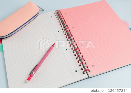 Open blank spiral bound lined notebook with a pencil and a pencil case Open blank spiral bound lined notebook with a pencil and a pencil case 126457254