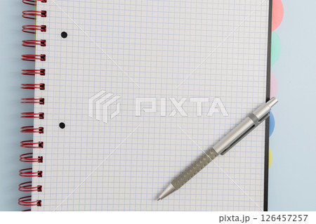 Open blank spiral bound squared notebook and pen Open blank spiral bound squared notebook and pen 126457257
