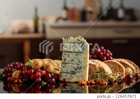Gorgonzola with ciabatta, walnuts, and grapes on a kitchen table. Gorgonzola with ciabatta, walnuts, and grapes on a kitchen table. 126457671