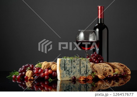 Gorgonzola cheese with ciabatta, walnuts, grapes, and red wine. Gorgonzola cheese with ciabatta, walnuts, grapes, and red wine. 126457677