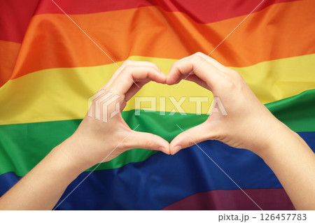 Hands showing heart and love against LGBT flag. 126457783