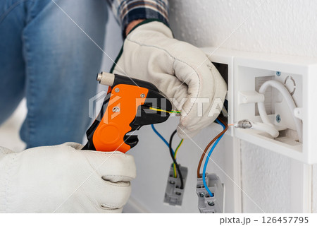 Electrician at work on a residential electrical system. Electricity. 126457795