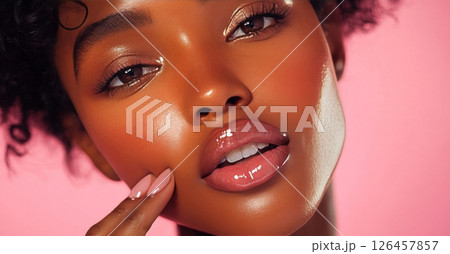 Beauty Portrait of Woman With Glowing Skin Against Pink Background Showcasing Natural Makeup 126457857