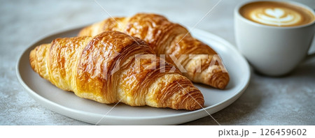 Delicious croissants with coffee in a cozy breakfast setup 126459602