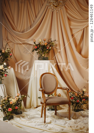 Empty Vintage Armchair with Roses and Draped Fabric in Styled Studio 126461149