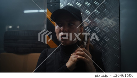 Female Police Officer Hiding Behind the Wall in Dark Office Building, Holding a Gun 126461500