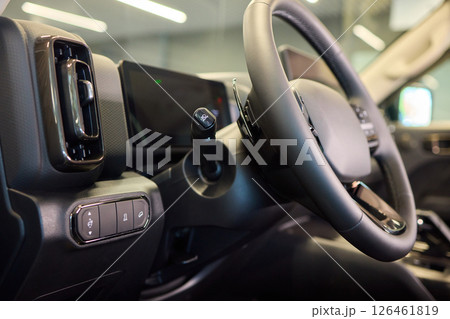 Closeup of a modern car steering wheel with control buttons for technology and convenience 126461819